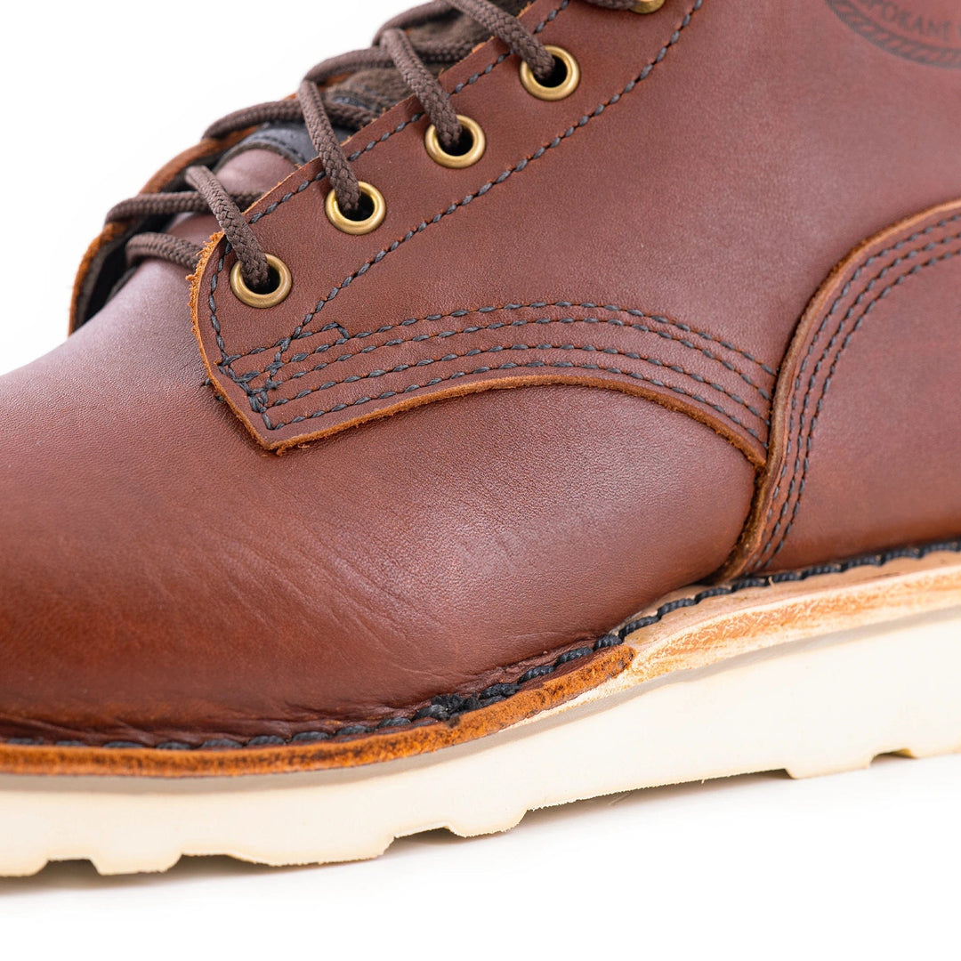 close up of the gold eyelets and brown laces.
