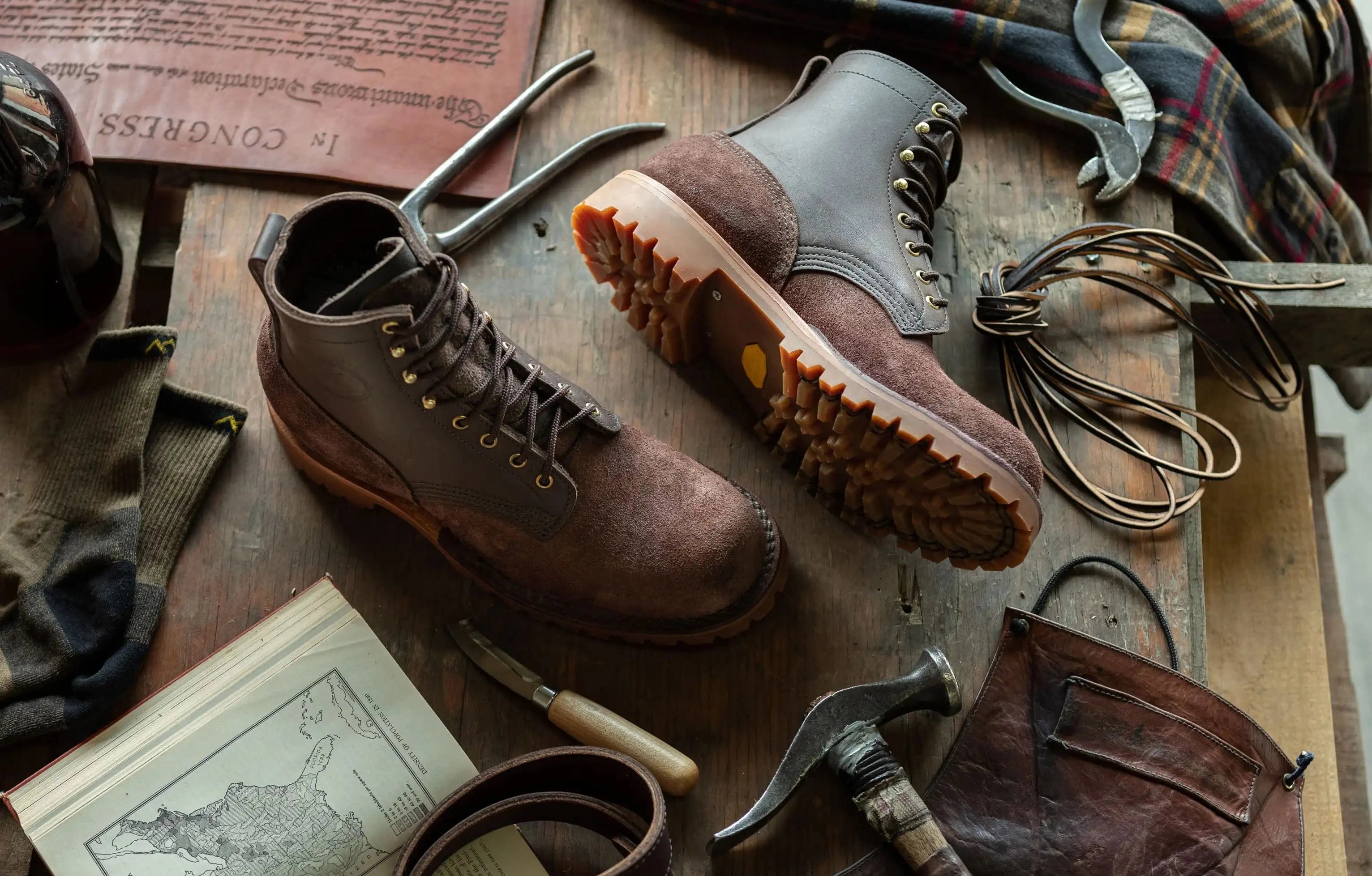 Americana brand image of jk boots and other old world tools and gear 