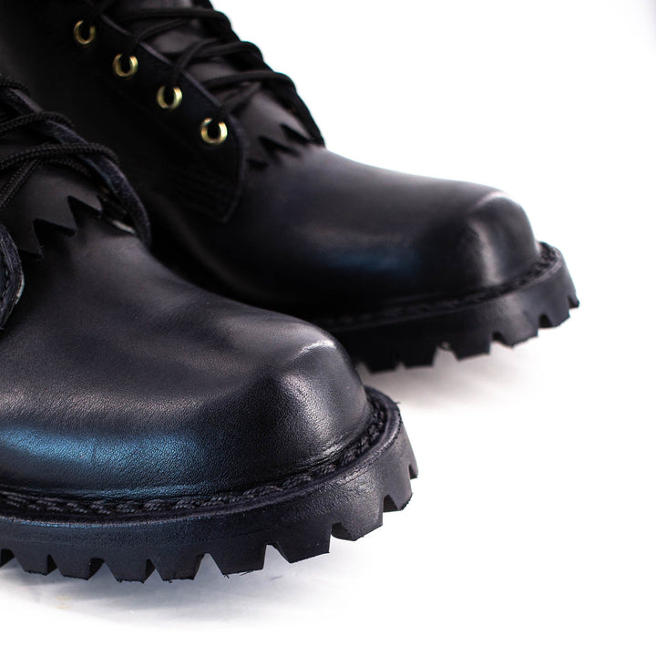 close up of boot toe and black stitching.