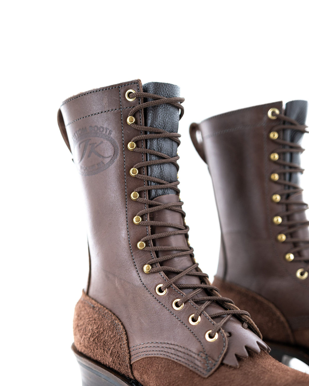 close up of the lacing and gold eyelets and hooks.