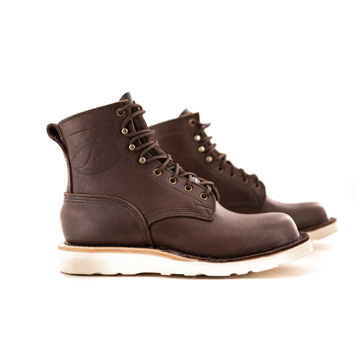 side profile showing the contrast between the brown boot and the white sole.