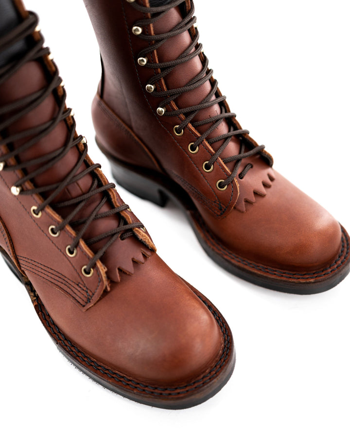 side view of the Harvester - Redwood. You can see the golden hooks and eyelets and the stitching from the top.