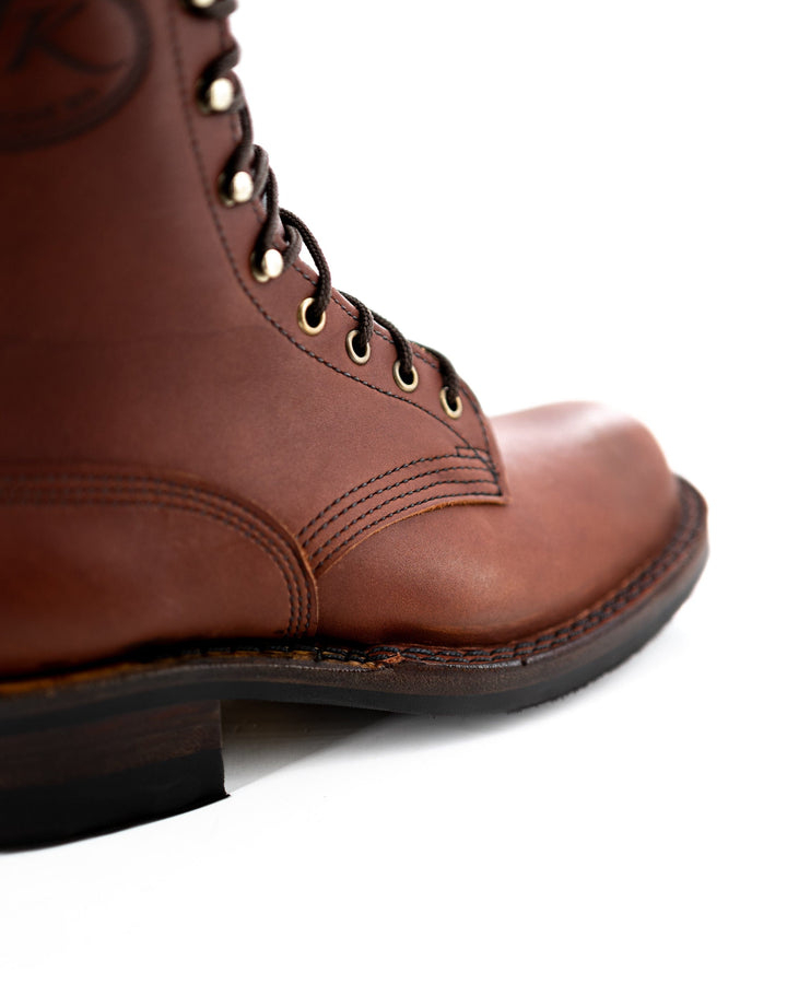 close up of the vamp showing the quality stitching and golden eyelets.