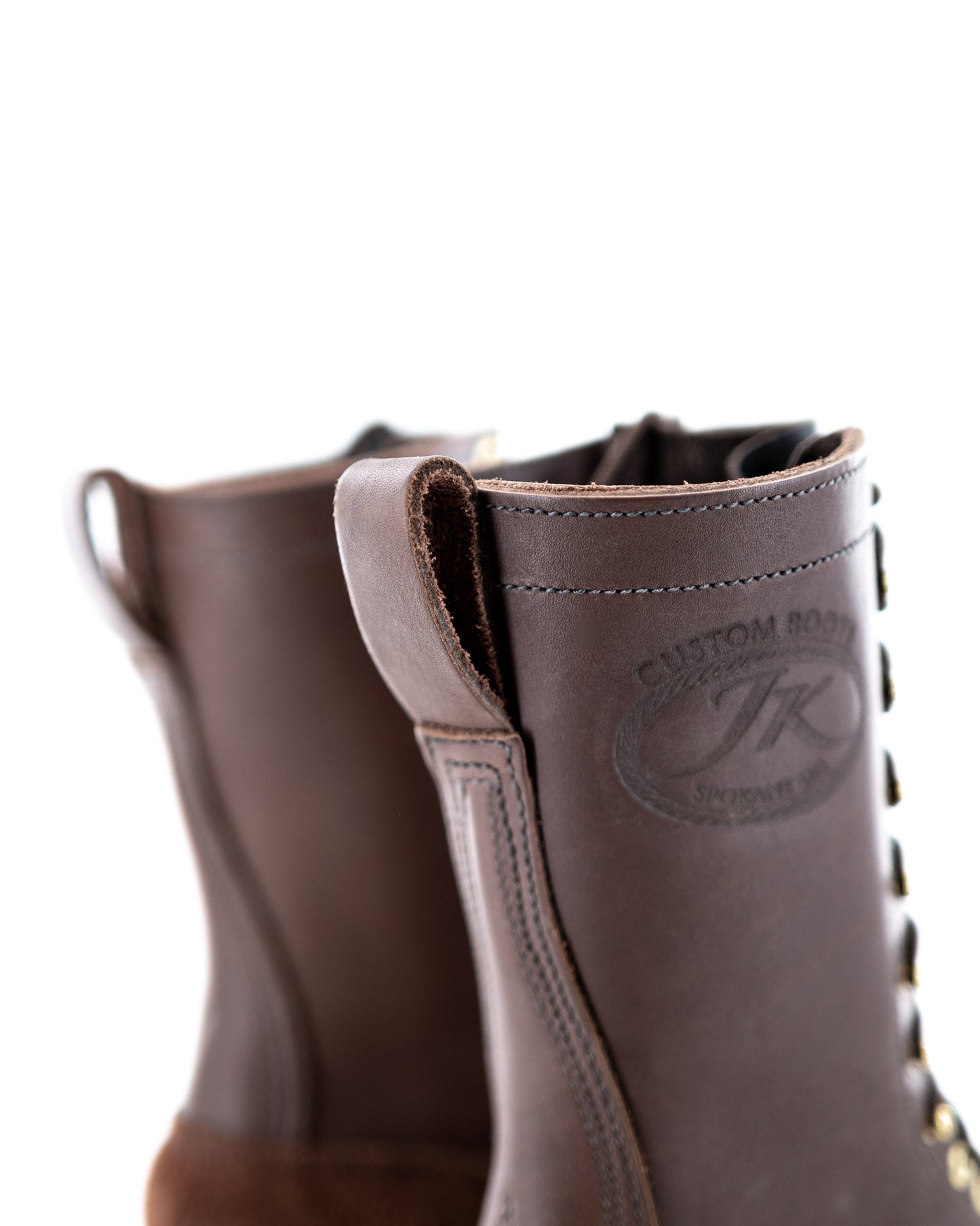 view of the rear pull tabs of the boot showing the JK stamp and the stitching around the top.